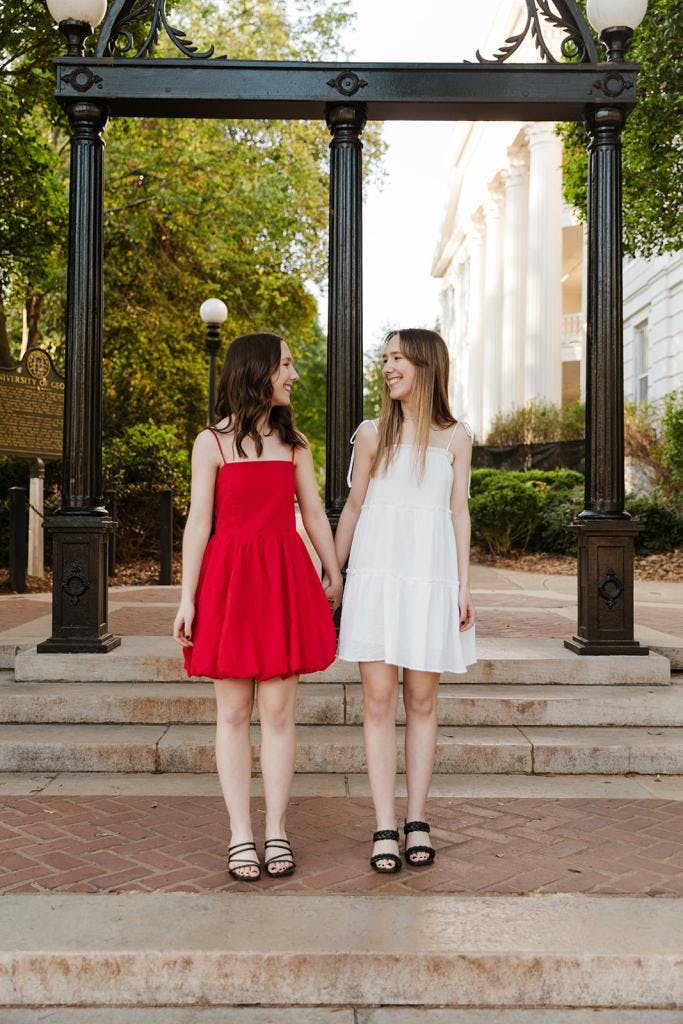 Chloe and Kristi Reid pose in front of the Arch