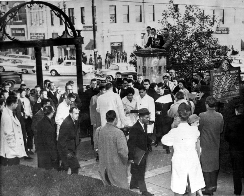 Charlyne Hunter and Hamilton Holmes are greeted by the press as they walk toward the Admissions Office on Jan. 9, 1961, to enroll as the first African American students at UGA.