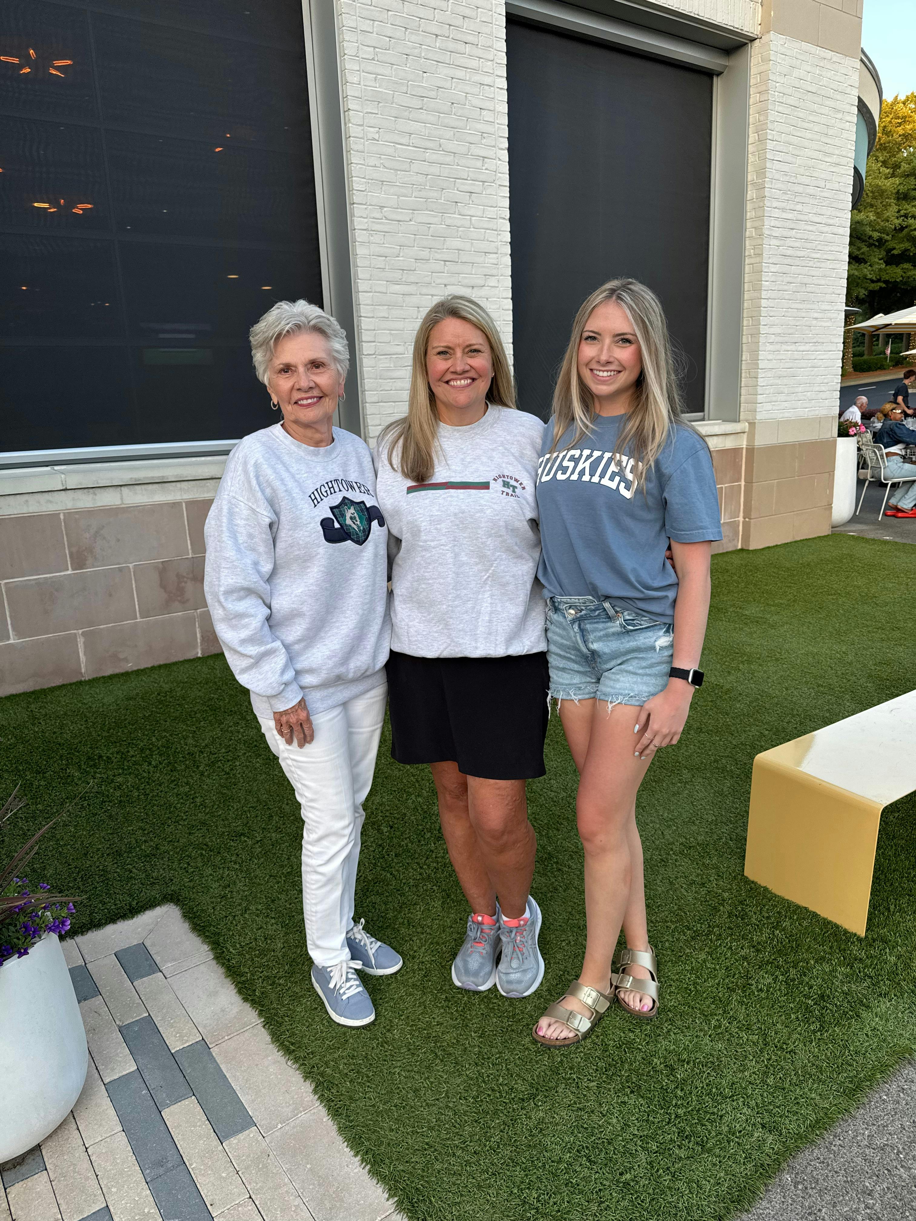Mackenzie Pease poses for a photo with her mother and grandmother, each wearing Hightower Trail apparel.