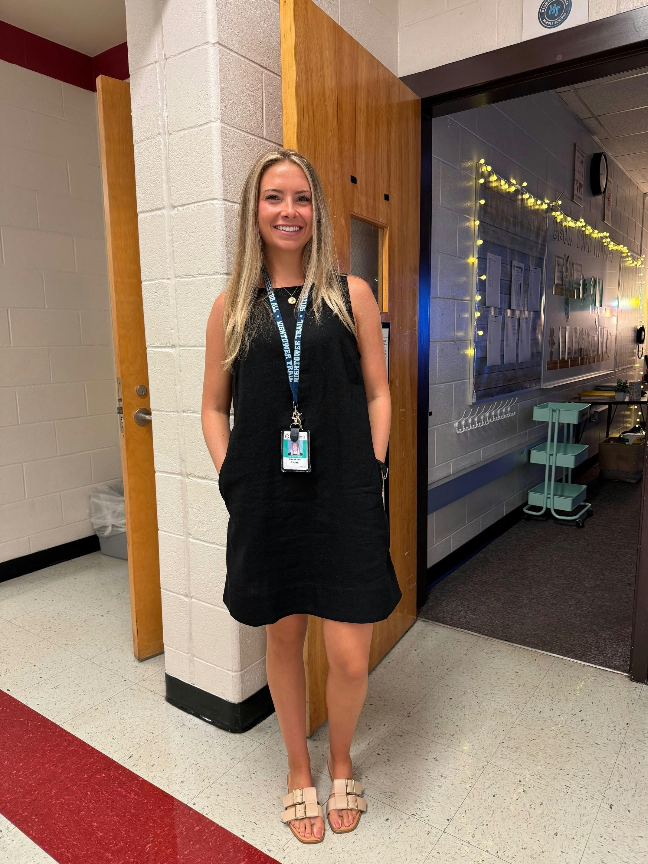 Mackenzie Pease poses outside her classroom.
