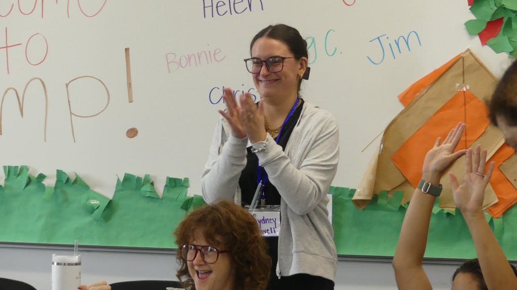 A student clinician supports participants of UGA's aphasia camp.