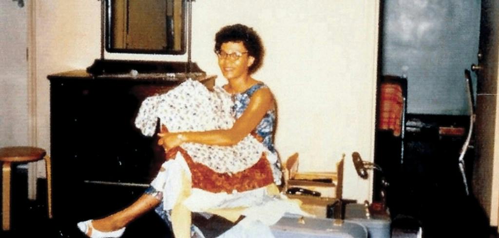 Mary Frances Early sits on a suitcase in the room she shared with Charlayne Hunter at UGA.